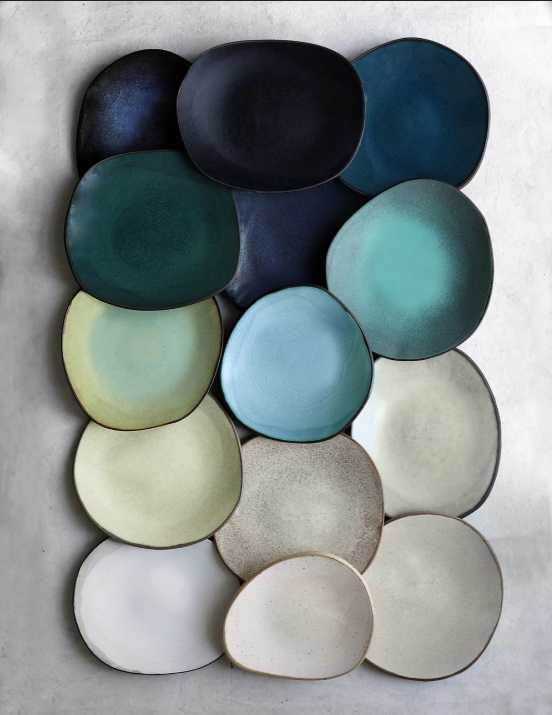 A collection of ceramic plates in ocean blues, soft greens and warm neutrals from Higo Blue